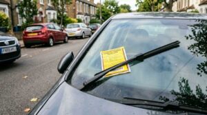 parking penalty notice under a car's wiper, showing the dropped kerb parking penalty